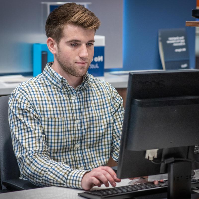 Student working in the on-campus banking center.