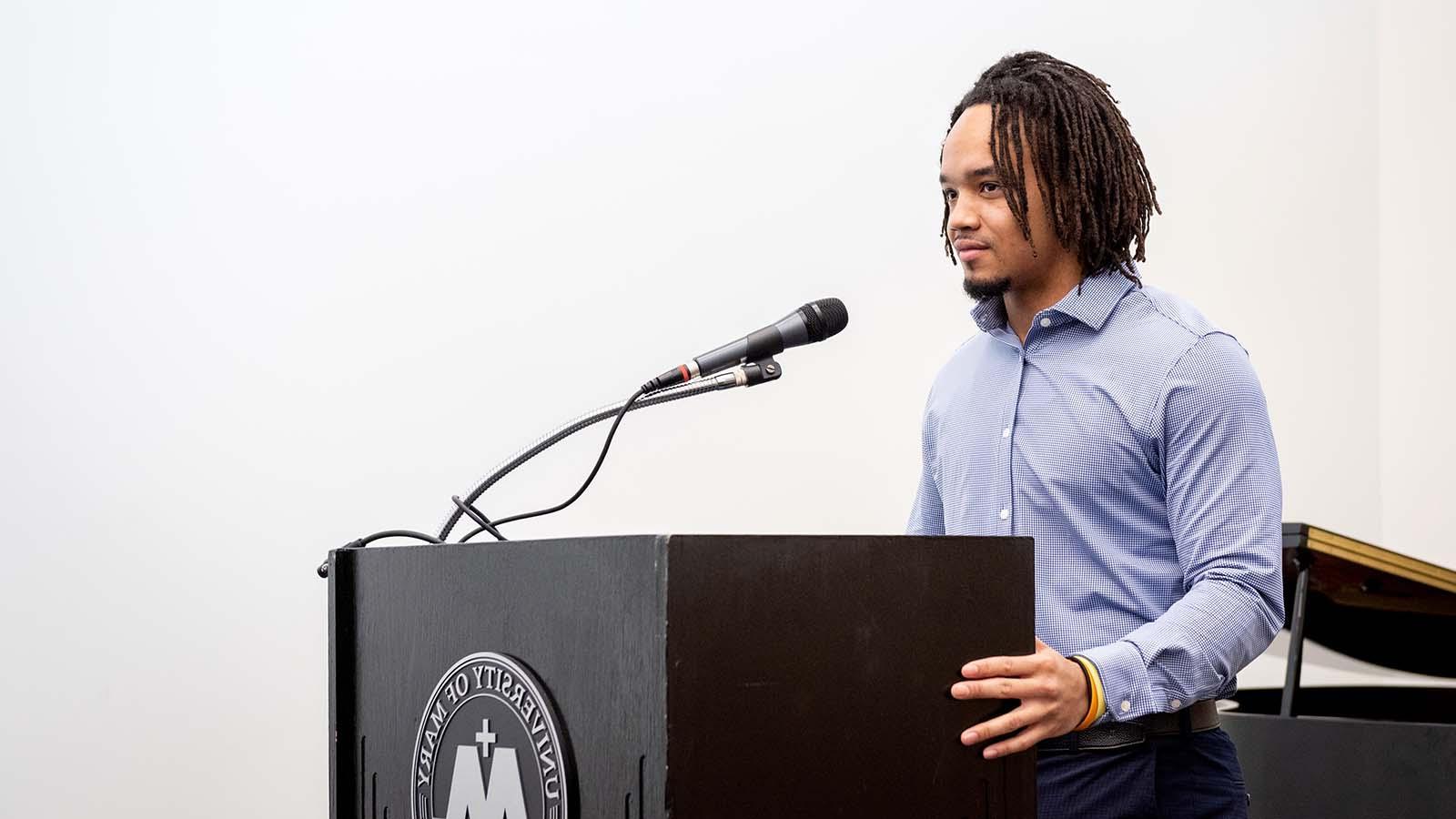 African american student at a podium giving a speech